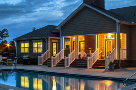 View of a pool and brightly lit porch