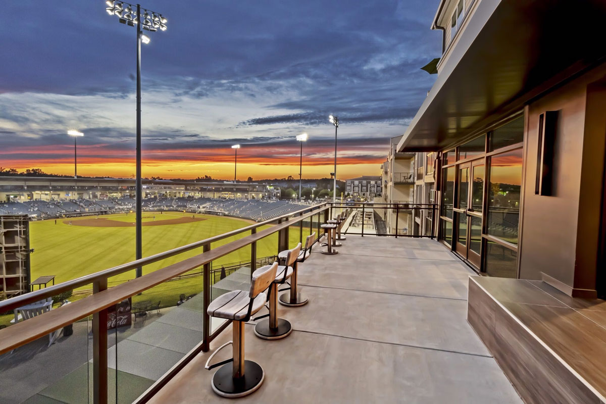 Photo of a balcony with seats and view of a baseball stadium