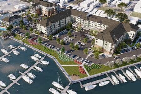 Aerial view of a Multifamily development on the water with boat docks and boats