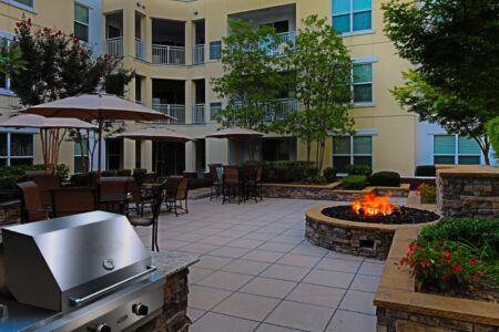 Multifamily property outdoor communal space with firepit and grill